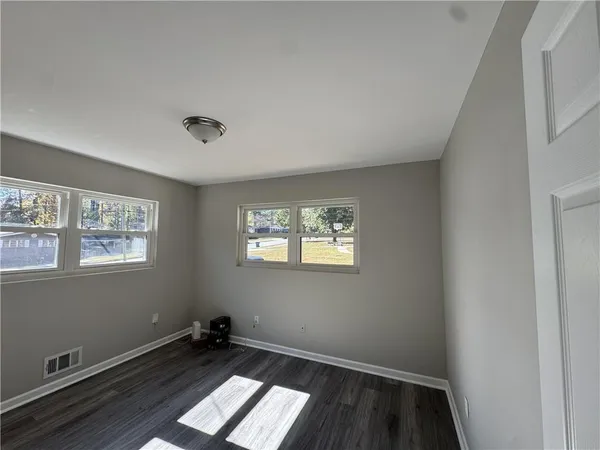 a kitchen with stainless steel appliances granite countertop a sink dishwasher stove and wooden floor