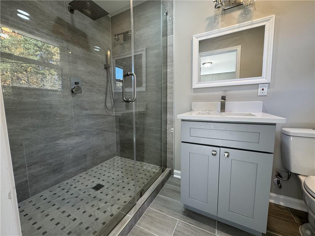 3489 Creighton Road Southwest Atlanta, GA 30331 - Photo 30 of 53 a bathroom with a sink a toilet a shower and a mirror