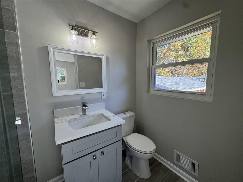 3489 Creighton Road Southwest Atlanta, GA 30331 - Photo 34 of 53 a bathroom with a toilet sink and mirror