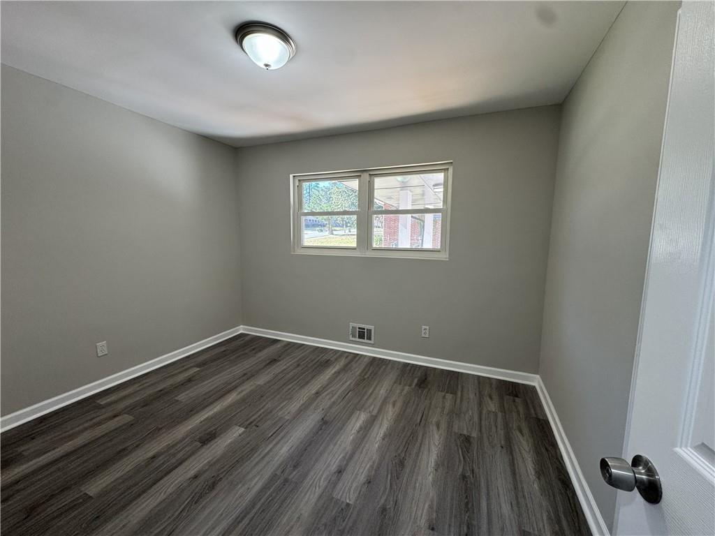3489 Creighton Road Southwest Atlanta, GA 30331 - Photo 37 of 53 an empty room with wooden floor and windows
