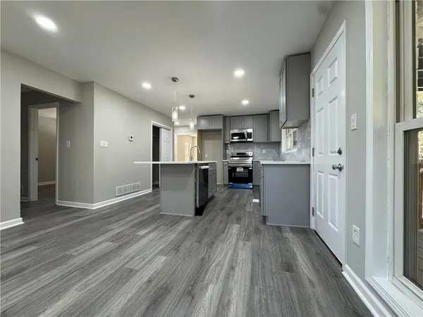 a kitchen with counter top space sink and appliances