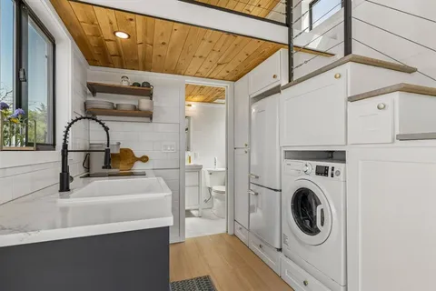 a bathroom with a sink a washer and dryer