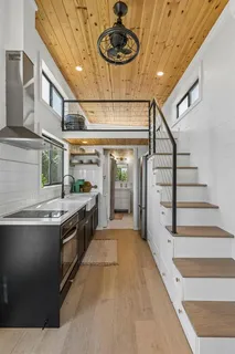 a view of a kitchen with furniture and a ceiling fan