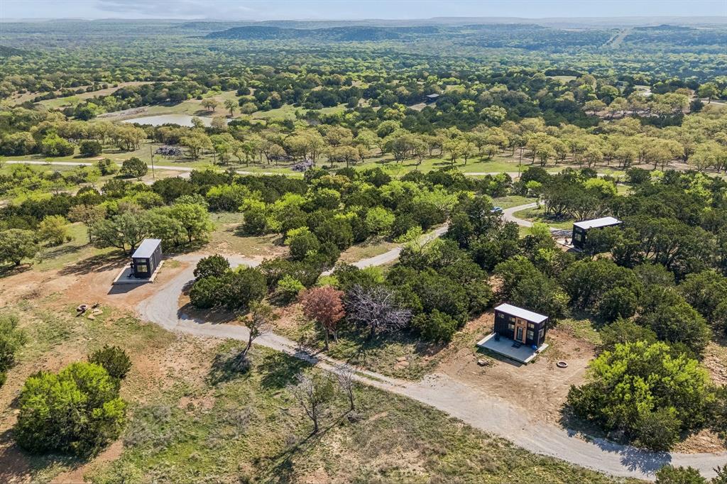 122 Western Sky Drive Ranger, TX 76470 - Photo 2 of 40 a view of a big yard with plants and large trees