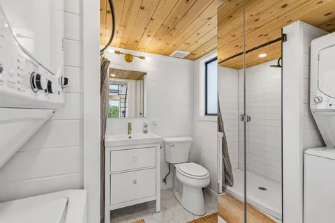 a bathroom with a toilet sink and shower