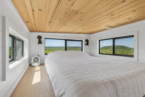 a large bed sitting in a bedroom next to a balcony