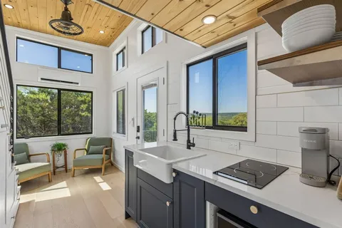 a kitchen with a sink and a stove top oven