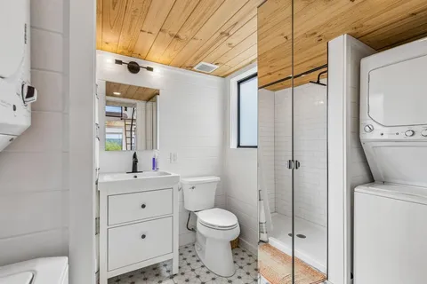 a bathroom with a toilet sink and shower