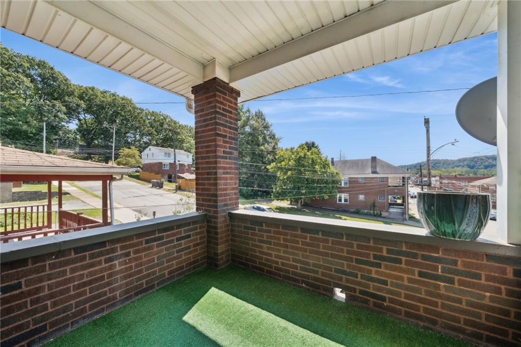 545 Sixth Street Trafford, PA 15085 - Photo 2 of 11 a view of a balcony with floor to ceiling windows with wooden floor