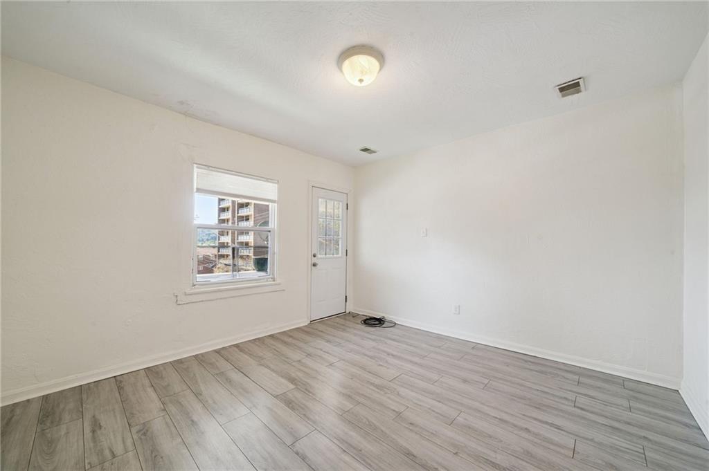 545 Sixth Street Trafford, PA 15085 - Photo 5 of 11 an empty room with wooden floor and windows