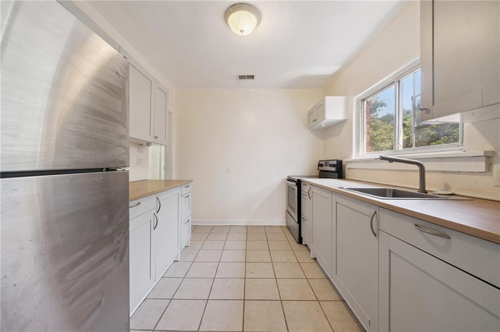 545 Sixth Street Trafford, PA 15085 - Photo 7 of 11 a view of a kitchen with a sink and a window