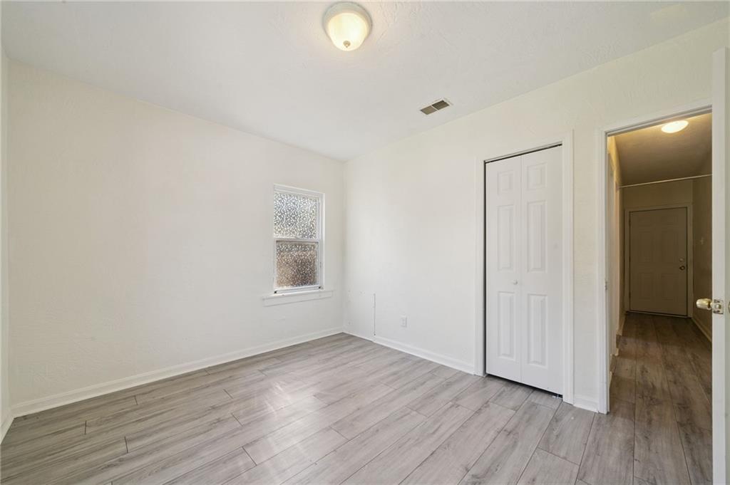 545 Sixth Street Trafford, PA 15085 - Photo 10 of 11 a view of an empty room with wooden floor and a window
