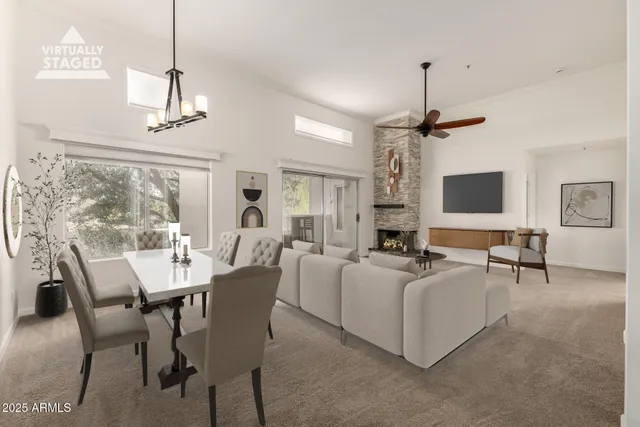 a living room with furniture a chandelier and a flat screen tv