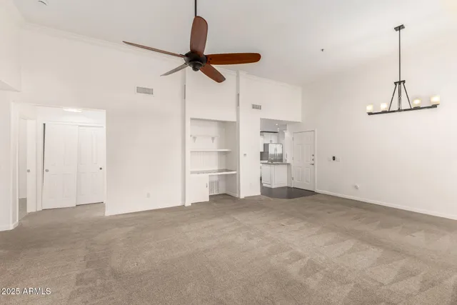 a view of a room with cabinet and a ceiling fan