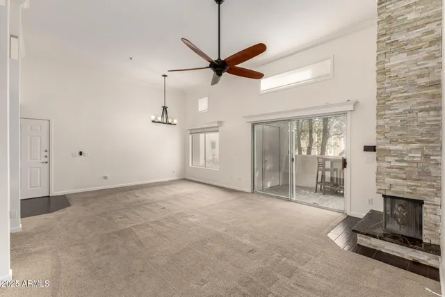 a view of a livingroom with a fireplace and window