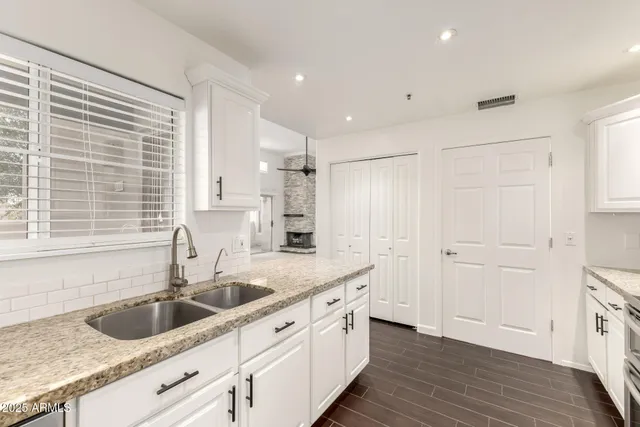a kitchen with a sink cabinets and window