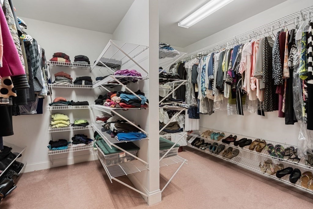 94 Cynthia Road Needham, MA 02494 - Photo 18 of 39 a view of walk in closet with clothes and shoes