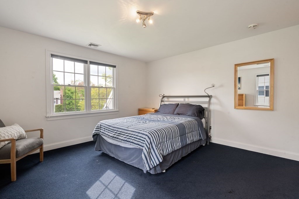 94 Cynthia Road Needham, MA 02494 - Photo 21 of 39 a bed sitting in a bedroom next to a window
