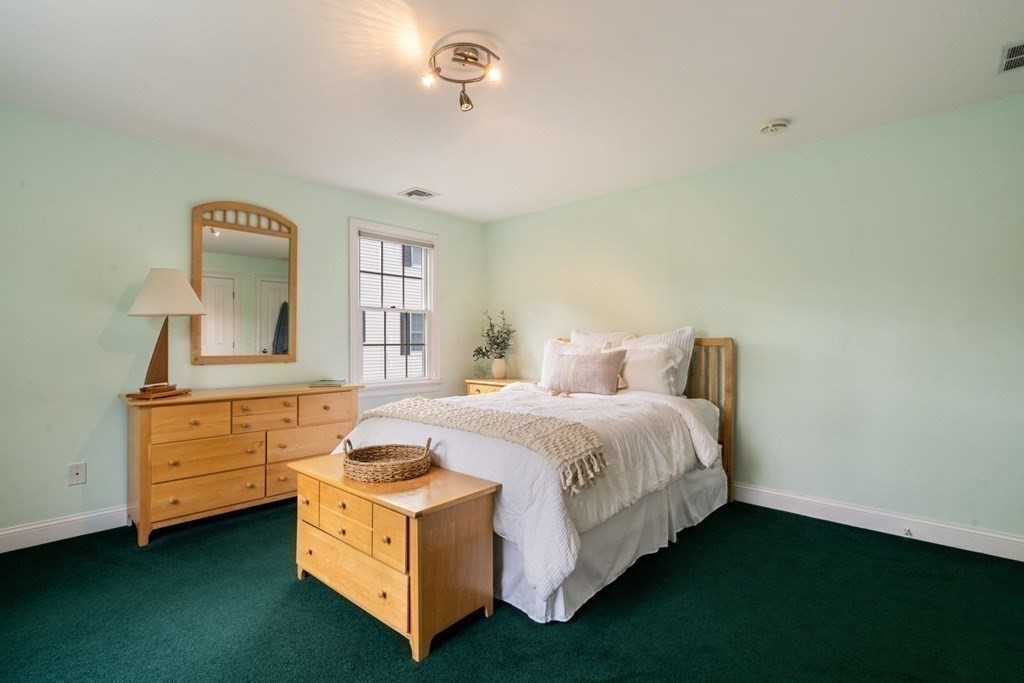 94 Cynthia Road Needham, MA 02494 - Photo 22 of 39 a spacious bedroom with a bed and a dresser