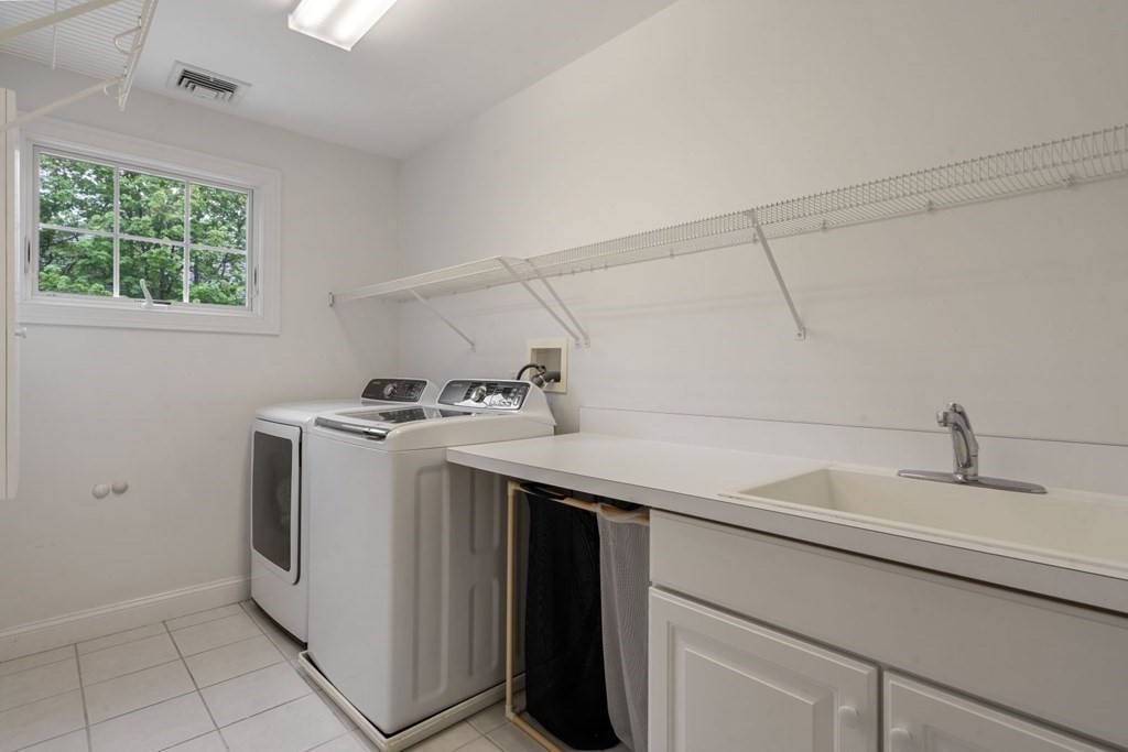94 Cynthia Road Needham, MA 02494 - Photo 27 of 39 a utility room with cabinets washer and dryer