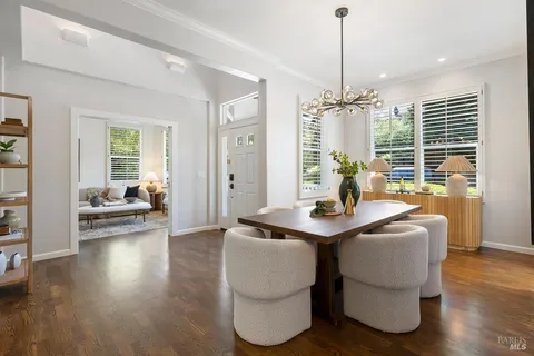 a living room with fireplace furniture and a wooden floor