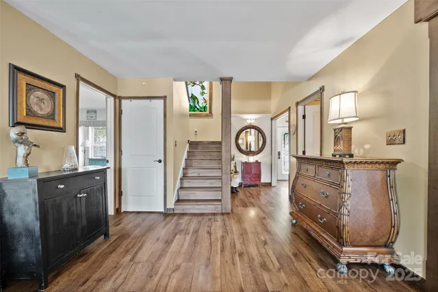a view of a hallway with wooden floor