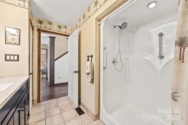 a bathroom with a tub shower and a sink