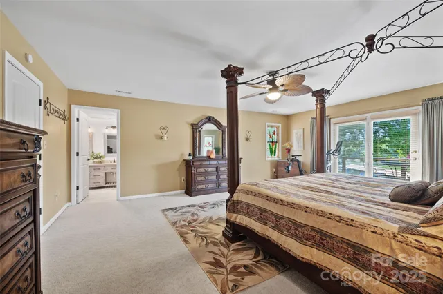 a bedroom with a bed closet and a large window