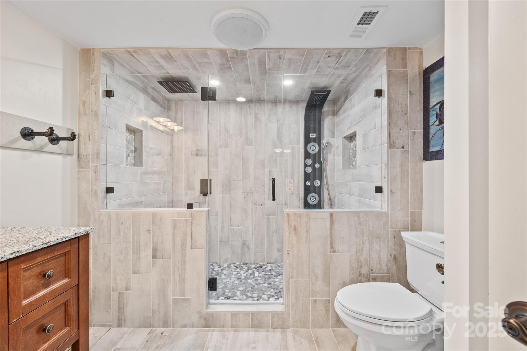 27056 Catamaran Drive Tega Cay, SC 29708 - Photo 26 of 48 a bathroom with a granite countertop sink a toilet a shower and a mirror