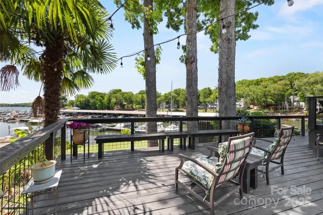 a view of a balcony with wooden floor and outdoor seating