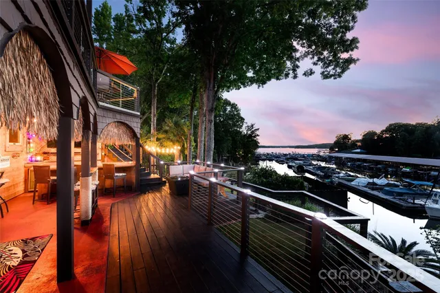 an aerial view of a house with a garden and lake view
