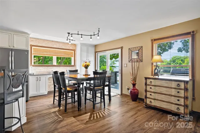 a view of a dining room with furniture window and wooden floor