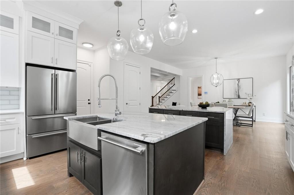 2415 West Rugby Avenue Atlanta, GA 30337 - Photo 11 of 40 a kitchen with stainless steel appliances granite countertop a refrigerator a sink a stove and a refrigerator