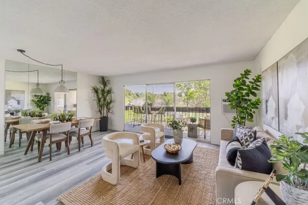 a living room with furniture and a potted plant