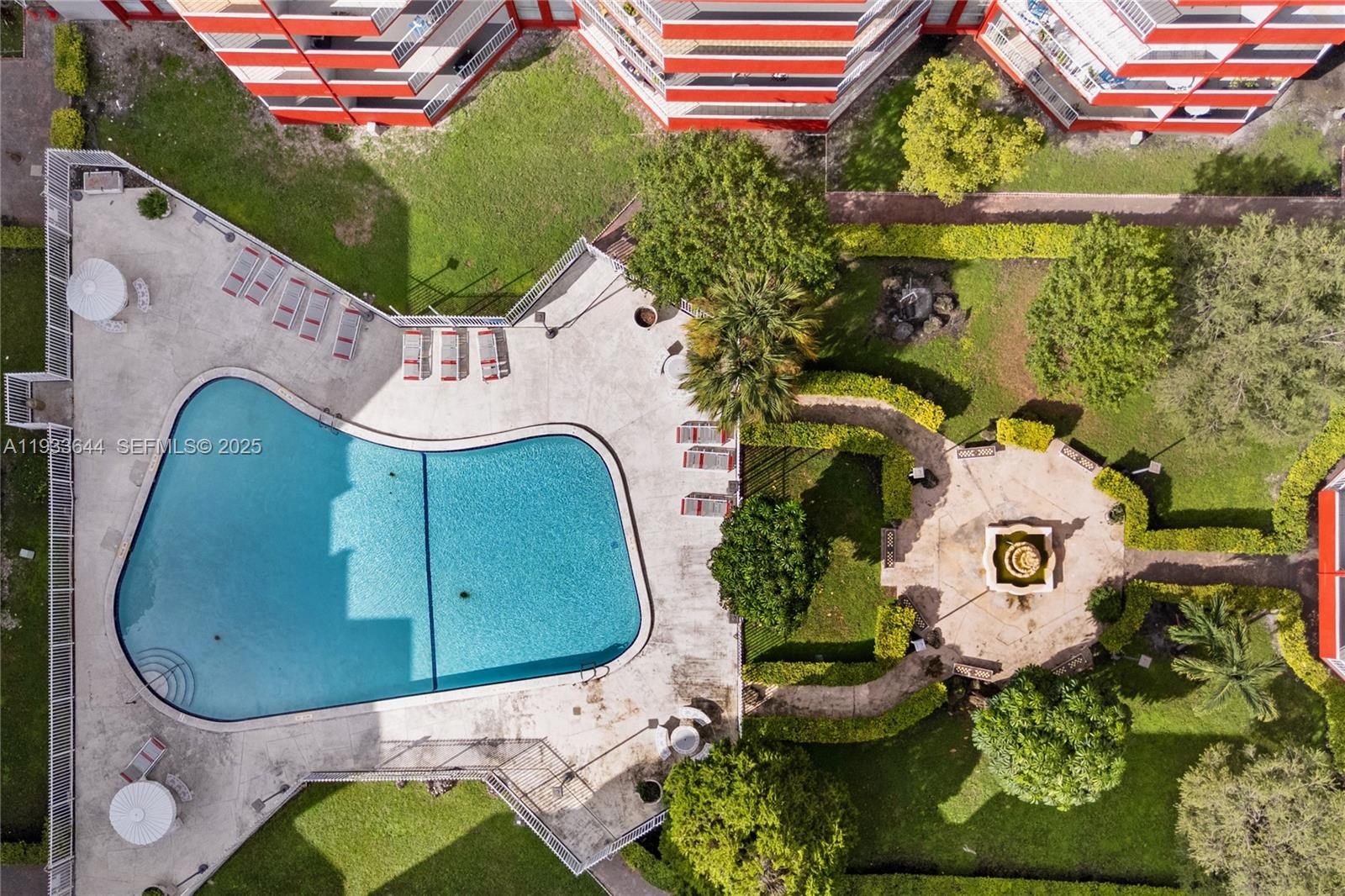 1750 West 46th Street, Unit 544 Hialeah, FL 33012 - Photo 28 of 44 an aerial view of a house with a swimming pool a yard and a fountain