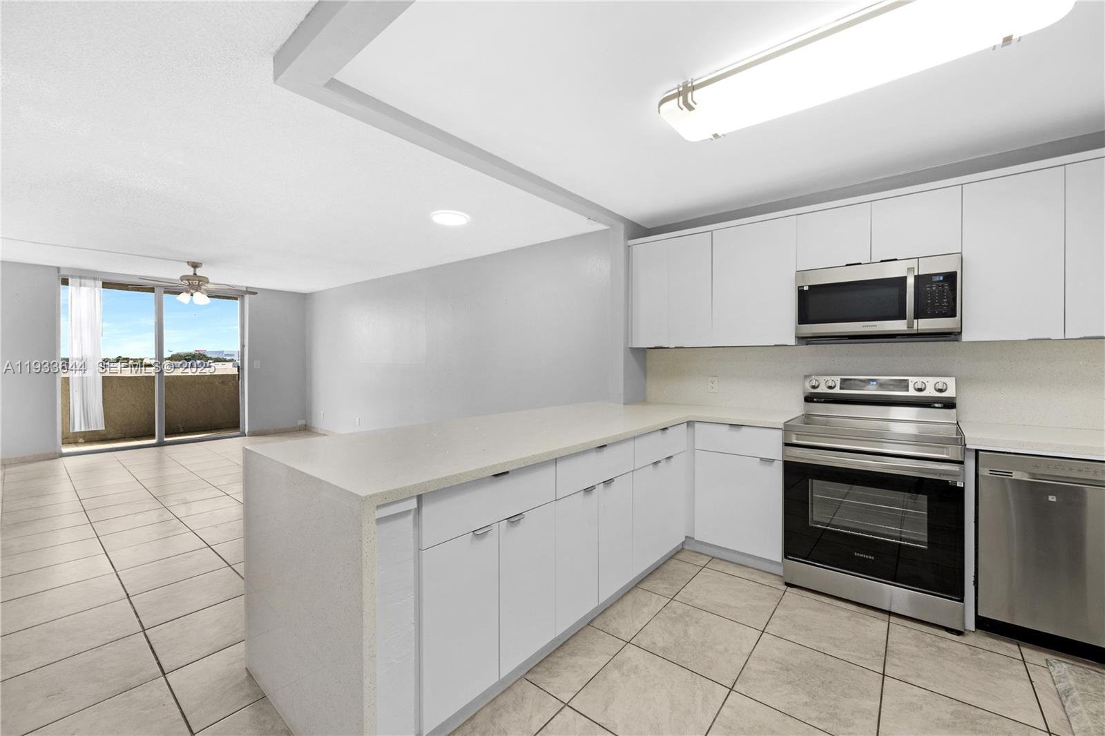 1750 West 46th Street, Unit 544 Hialeah, FL 33012 - Photo 4 of 44 a kitchen with granite countertop a sink and steel appliances