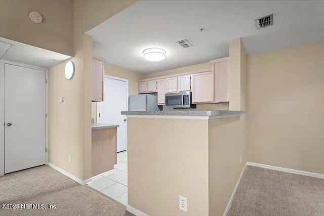 a kitchen with stainless steel appliances granite countertop a sink stove and microwave