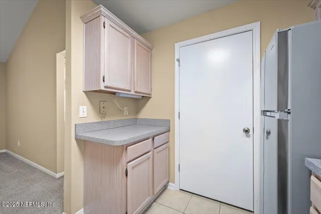 an empty room with ceiling fan and windows