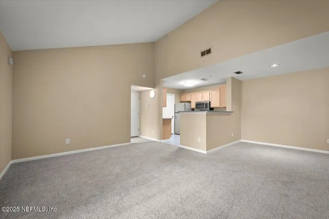 a kitchen with granite countertop white cabinets stainless steel appliances and a sink