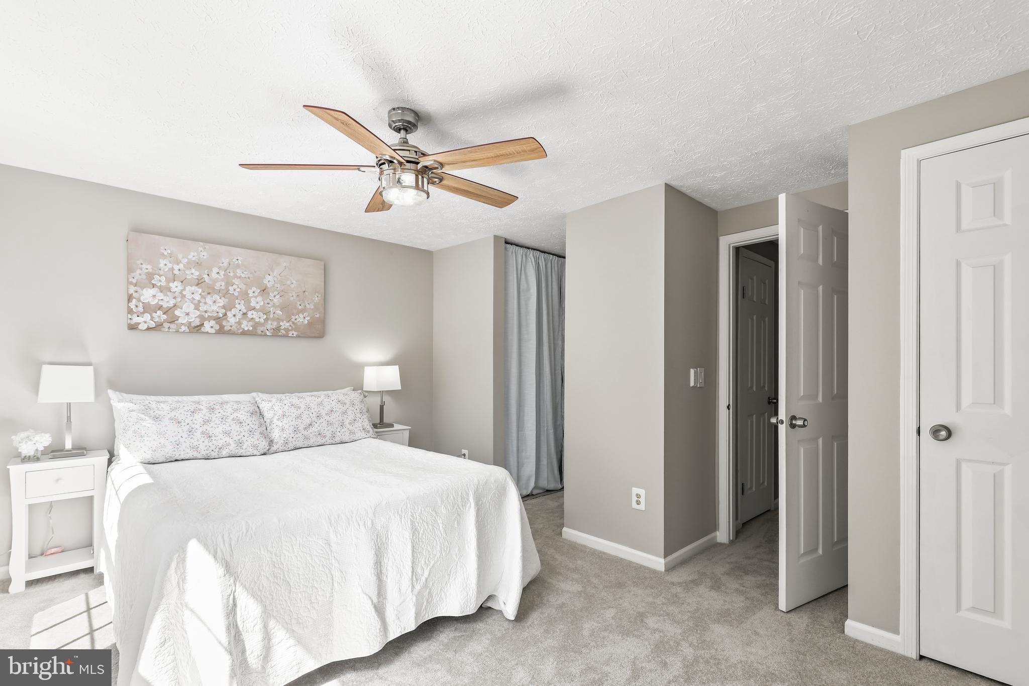 1937 Belmont Ridge Court Reston, VA 20191 - Photo 9 of 23 a bedroom with a large bed and a chandelier