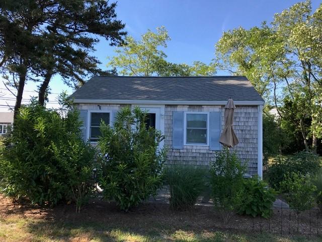 125 Shore Road, Unit 1 Truro, MA 02666 - Photo 7 of 8 a front view of a house with a garden