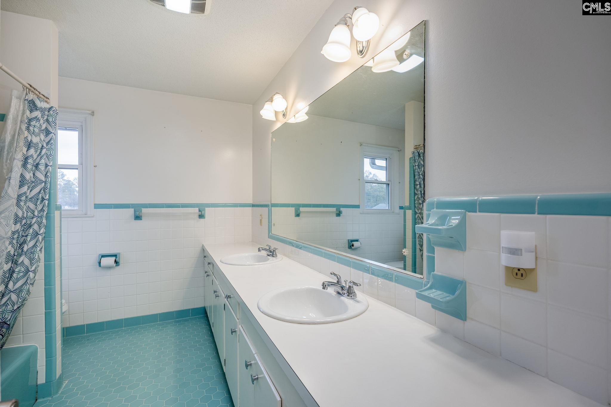 560 Edisto Street Batesburg, SC 29006 - Photo 32 of 49 a bathroom with a double vanity sink and a mirror