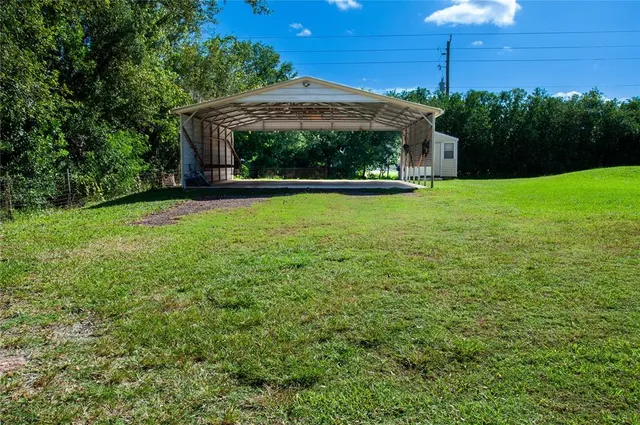 a view of a garden with a small barn