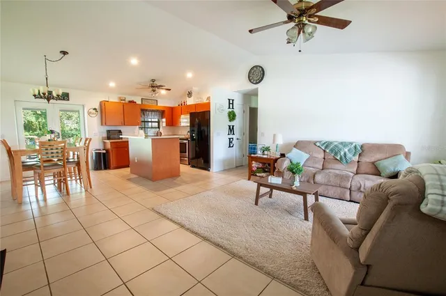 a living room with furniture and kitchen view