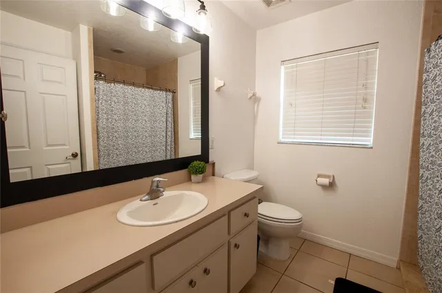 a bathroom with a sink toilet and a mirror