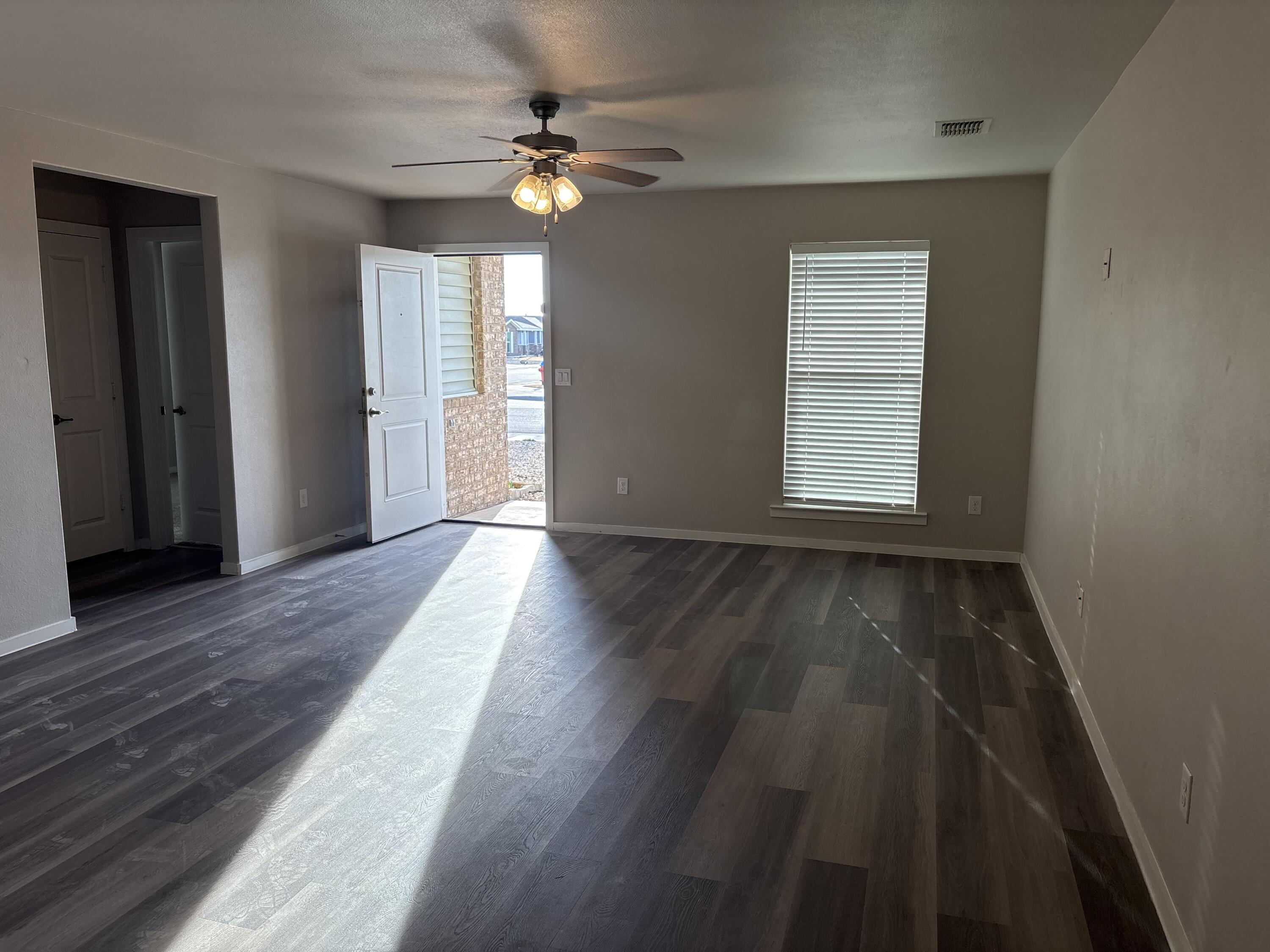 13809 Paris Lubbock, TX 79423 - Photo 11 of 19 an empty room with wooden floor fan and windows