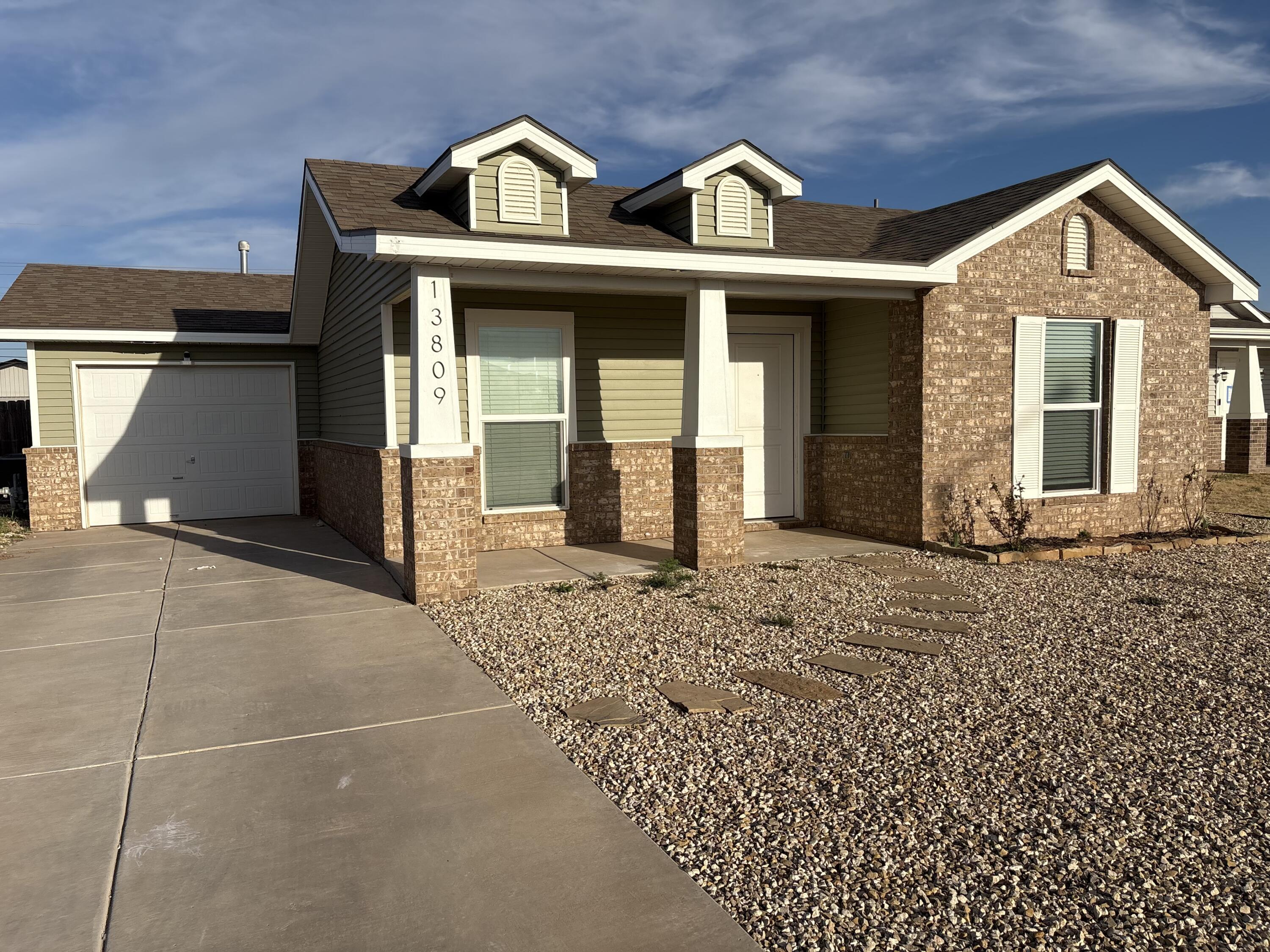 13809 Paris Lubbock, TX 79423 - Photo 18 of 19 a view of a brick house with large windows
