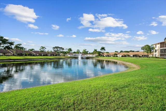 a view of a lake with a house in the background