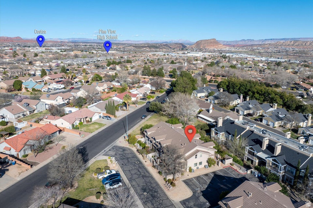 345 North 2450th Street East, Unit 152 St. George, UT 84790 - Photo 31 of 40 Aerial overview of property's location with a mountain backdrop and nearby suburban area