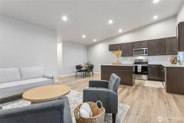 a living room with furniture a kitchen view and a sink